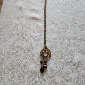 Gold toned Eternity CIrcle Necklace with purple colored Jewels 17"